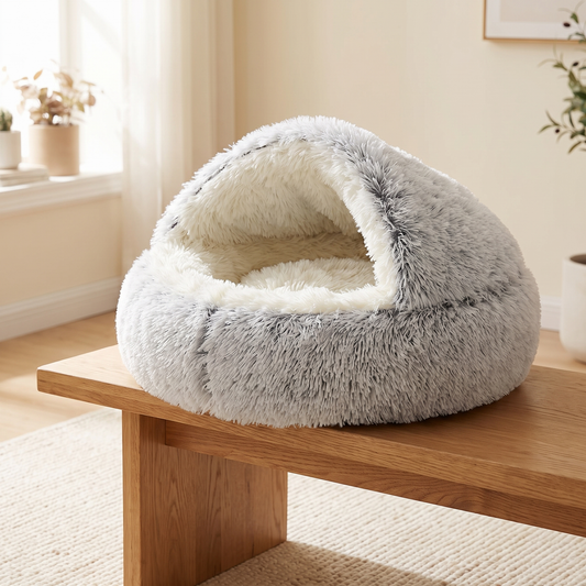 Nestly cat cave bed with the hood up on an oak bench